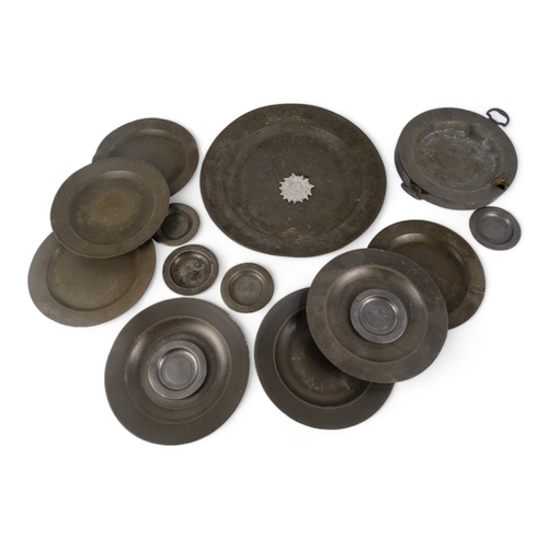 118 - A pewter charger - diameter 37.5cm, together with seven pewter plates, a pewter warming dish and oth... 