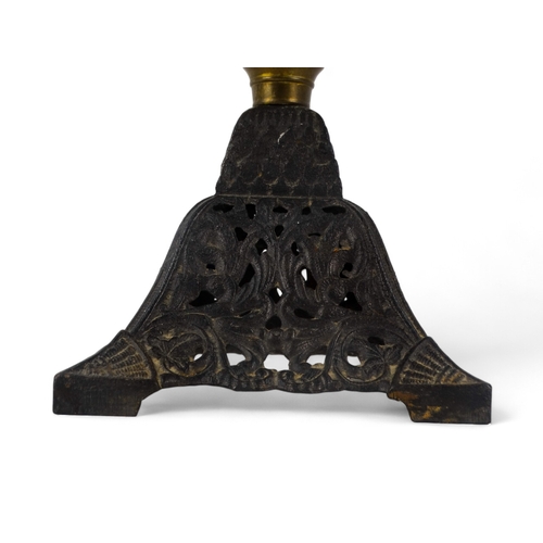 125 - A late 19th century oil lamp - with faceted clear glass reservoir, on a square tapering cast iron ba... 