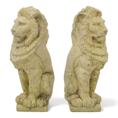 130 - A pair of reconstituted stone lions - height 34cm.