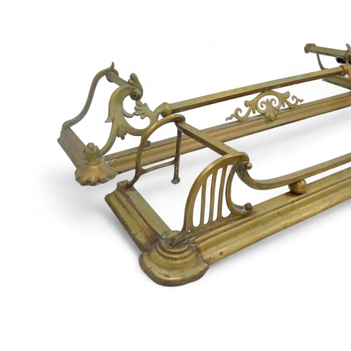 135 - Two brass fenders - largest width 130cm, depth 28cm, together with a pair of wooden bellows carved w... 