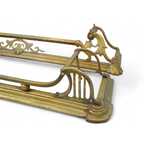 135 - Two brass fenders - largest width 130cm, depth 28cm, together with a pair of wooden bellows carved w... 