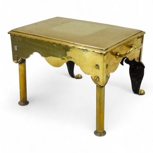 15 - A 19th century brass footman - rectangular with twin handles and raised on cabriole legs, 44cm wide.