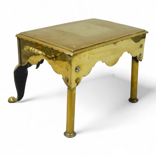 15 - A 19th century brass footman - rectangular with twin handles and raised on cabriole legs, 44cm wide.