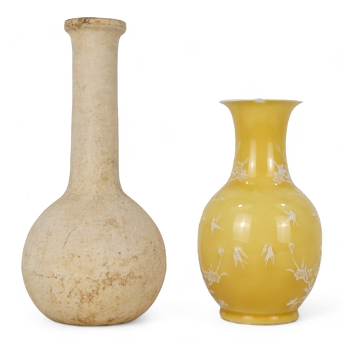 166 - An early 20th century baluster shaped vase - yellow glazed with white low relief design of birds and... 