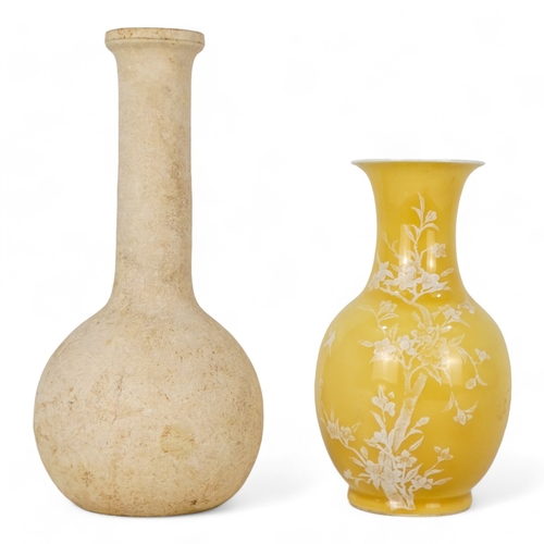 166 - An early 20th century baluster shaped vase - yellow glazed with white low relief design of birds and... 