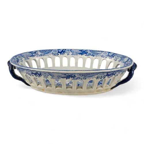 168 - An early 19th century blue and white pottery bread basket - oval with twin handles and decorated wit... 