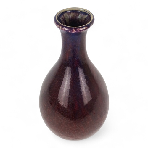 192 - A 20th century sang de boeuf glazed vase - of baluster form, height 43cm.