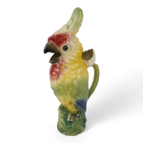 195 - A late 19th century jug - modelled in the form of a cockatoo, 36cm high.