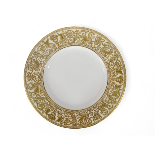 203 - A 20th century Wedgwood dinner service - for eight place settings, white with a gilt 'Florentine' pa... 