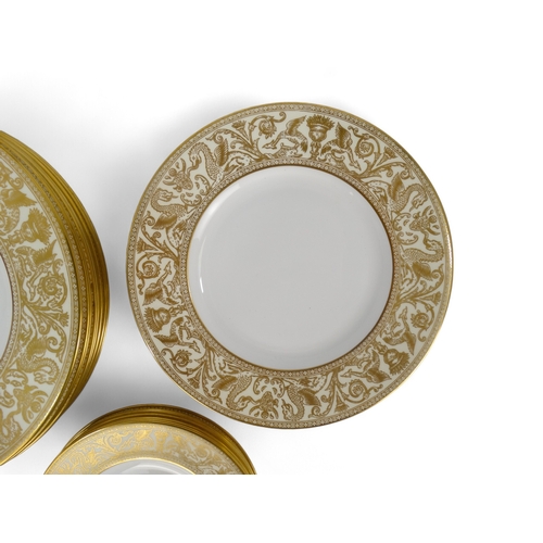 203 - A 20th century Wedgwood dinner service - for eight place settings, white with a gilt 'Florentine' pa... 