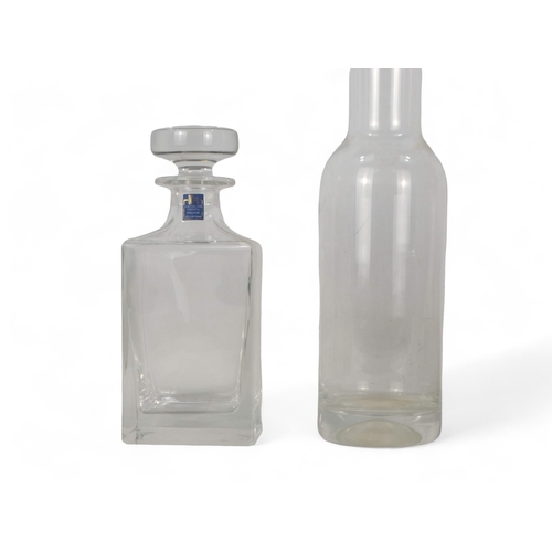 206 - A Dartington Crystal decanter - of plain square form, 22cm high, boxed, together with a water carafe... 