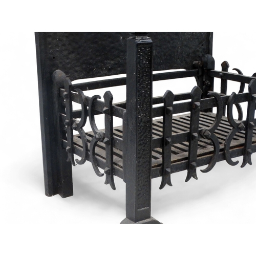 25 - A rectangular fire grate - with an openwork basket and a cast iron fire back decorated with a fleur ... 