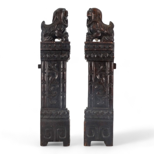 269 - A pair of late 19th/early 20th century carved hardwood table screen stiles - surmounted by dog of fo... 