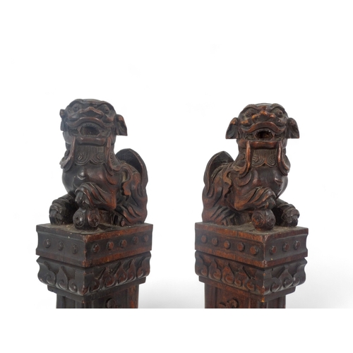 269 - A pair of late 19th/early 20th century carved hardwood table screen stiles - surmounted by dog of fo... 