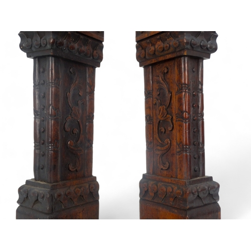 269 - A pair of late 19th/early 20th century carved hardwood table screen stiles - surmounted by dog of fo... 