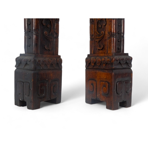 269 - A pair of late 19th/early 20th century carved hardwood table screen stiles - surmounted by dog of fo... 