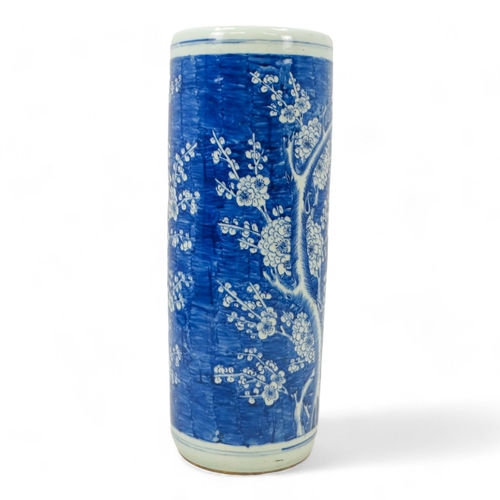 272 - A 20th century Chinese blue and white stick stand - of cylindrical form and decorated with prunus pa... 