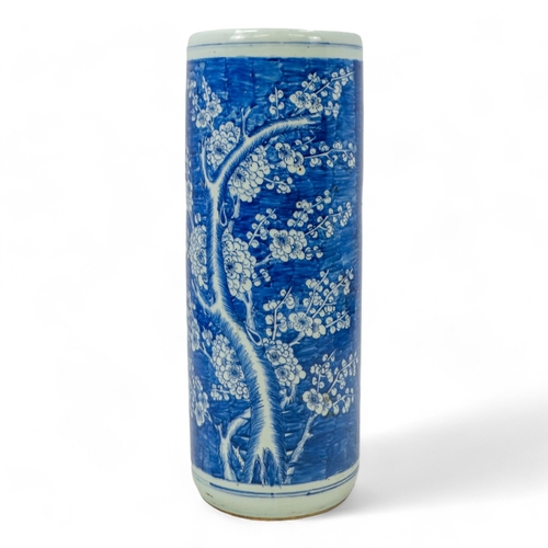 272 - A 20th century Chinese blue and white stick stand - of cylindrical form and decorated with prunus pa... 