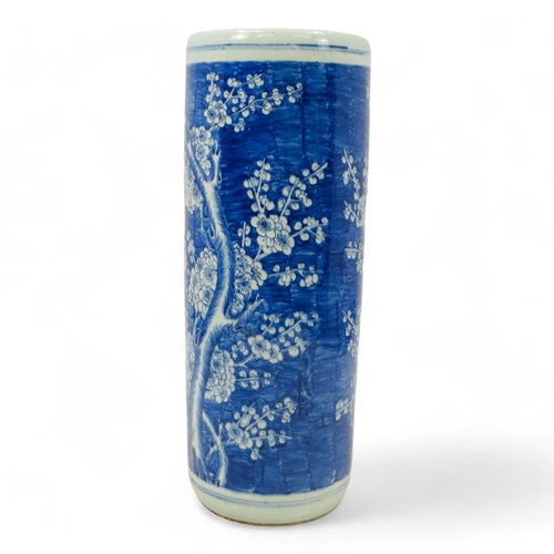 272 - A 20th century Chinese blue and white stick stand - of cylindrical form and decorated with prunus pa... 