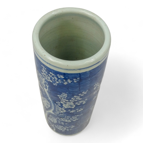 272 - A 20th century Chinese blue and white stick stand - of cylindrical form and decorated with prunus pa... 