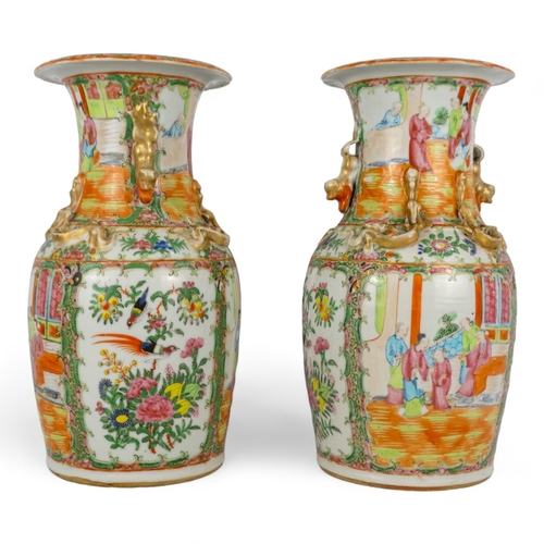 277 - A pair of 19th century Cantonese vases - of baluster form with famille verte decoration showing figu... 