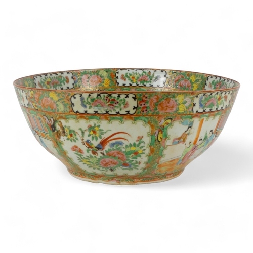 280 - A late 19th century Cantonese famille verte punch bowl - of large proportions and decorated in typic... 