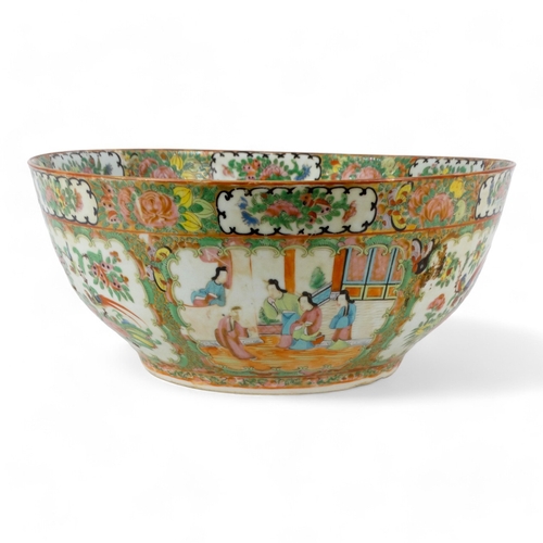 280 - A late 19th century Cantonese famille verte punch bowl - of large proportions and decorated in typic... 