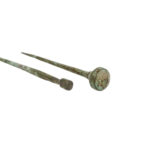 40 - A Romano-British bronze hair pin - 5cm long, together with another longer example. (2)