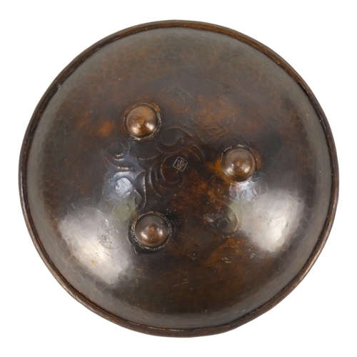 49 - Hugh Wallis (British, 1871-1943) a copper shallow bowl with pewter decoration - raised on three butt... 