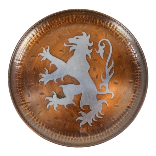 50 - Hugh Wallis (British, 1871-1943) a copper and pewter dish - decorated with a lion, signed with initi... 