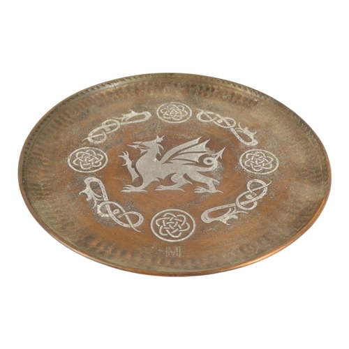 51 - Hugh Wallis (British, 1871-1943) a copper and pewter dish - decorated with a dragon, signed with ini... 