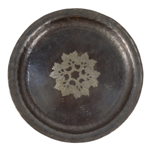 52 - Hugh Wallis (British, 1871-1943) a copper and pewter dish - decorated with a band of foliage, signed... 