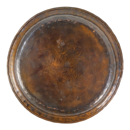 52 - Hugh Wallis (British, 1871-1943) a copper and pewter dish - decorated with a band of foliage, signed... 