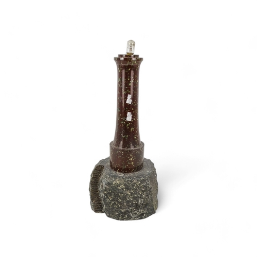 55 - An early 20th century turned serpentine lighthouse - on a rocky base, lacking lantern, 41cm high.