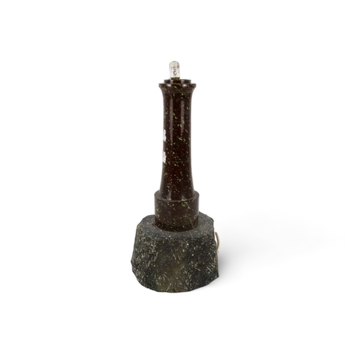 55 - An early 20th century turned serpentine lighthouse - on a rocky base, lacking lantern, 41cm high.