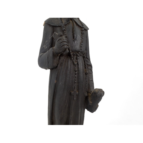 57 - A terracotta figure of an African priest - 41cm high.