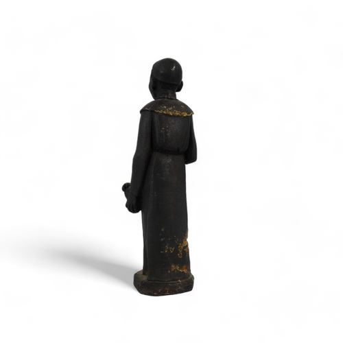 57 - A terracotta figure of an African priest - 41cm high.