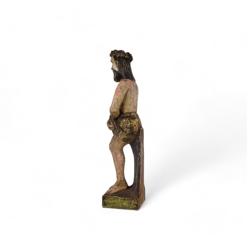 66 - A wooden statue of Christ - with hands bound, remnants of paint, height 50cm.