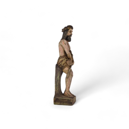 66 - A wooden statue of Christ - with hands bound, remnants of paint, height 50cm.