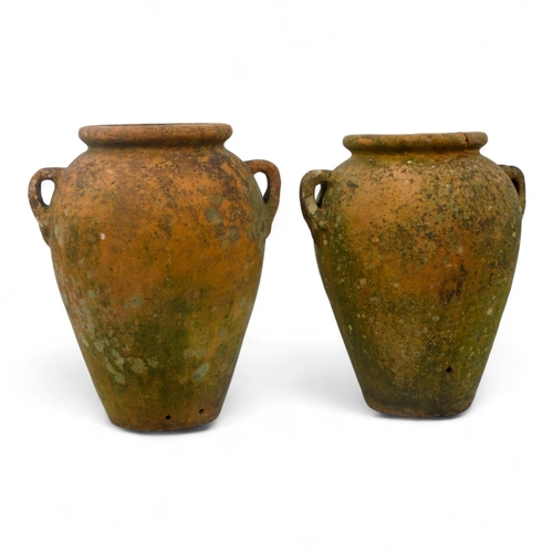 67 - A pair of twin handled terracotta olive jars - one with a tap, height 53cm, diameter 37cm.