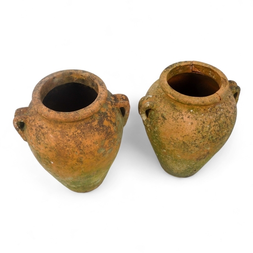 67 - A pair of twin handled terracotta olive jars - one with a tap, height 53cm, diameter 37cm.