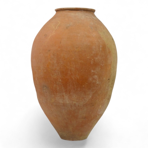 69 - A terracotta olive jar - with turned rim, height 69cm, diameter 42cm.