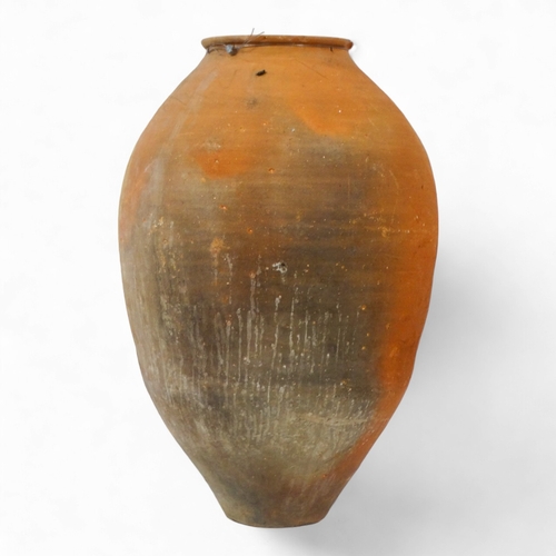 69 - A terracotta olive jar - with turned rim, height 69cm, diameter 42cm.