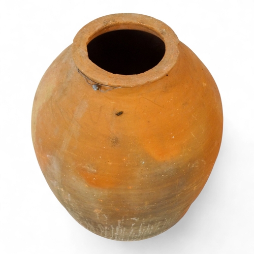 69 - A terracotta olive jar - with turned rim, height 69cm, diameter 42cm.