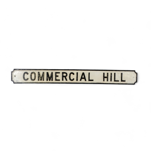 7 - A cast iron road sign - 'Commercial Hill', rectangular with re-entrant corners, 111cm wide.