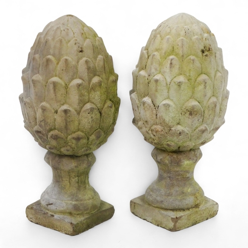 84 - A pair of reconstituted stone artichokes - height 30cm.