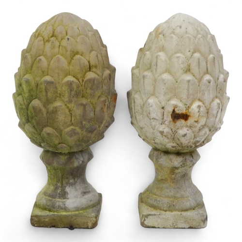 84 - A pair of reconstituted stone artichokes - height 30cm.