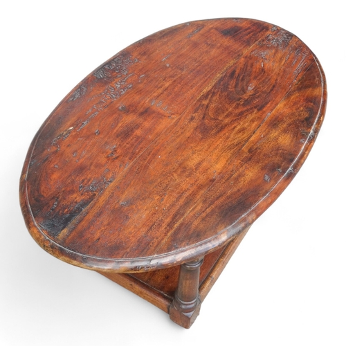 949 - A 20th century hardwood low table - the oval moulded top on square turned legs joined by an undertie... 