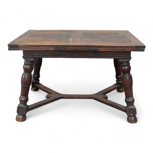 950 - A Spanish style oak draw-leaf table - the rectangular top with geometric veneers, on splayed square ... 