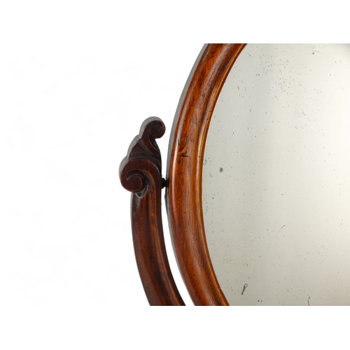 952 - A Victorian mahogany toilet mirror - with an oval plate between shaped supports on an ogee shaped ba... 